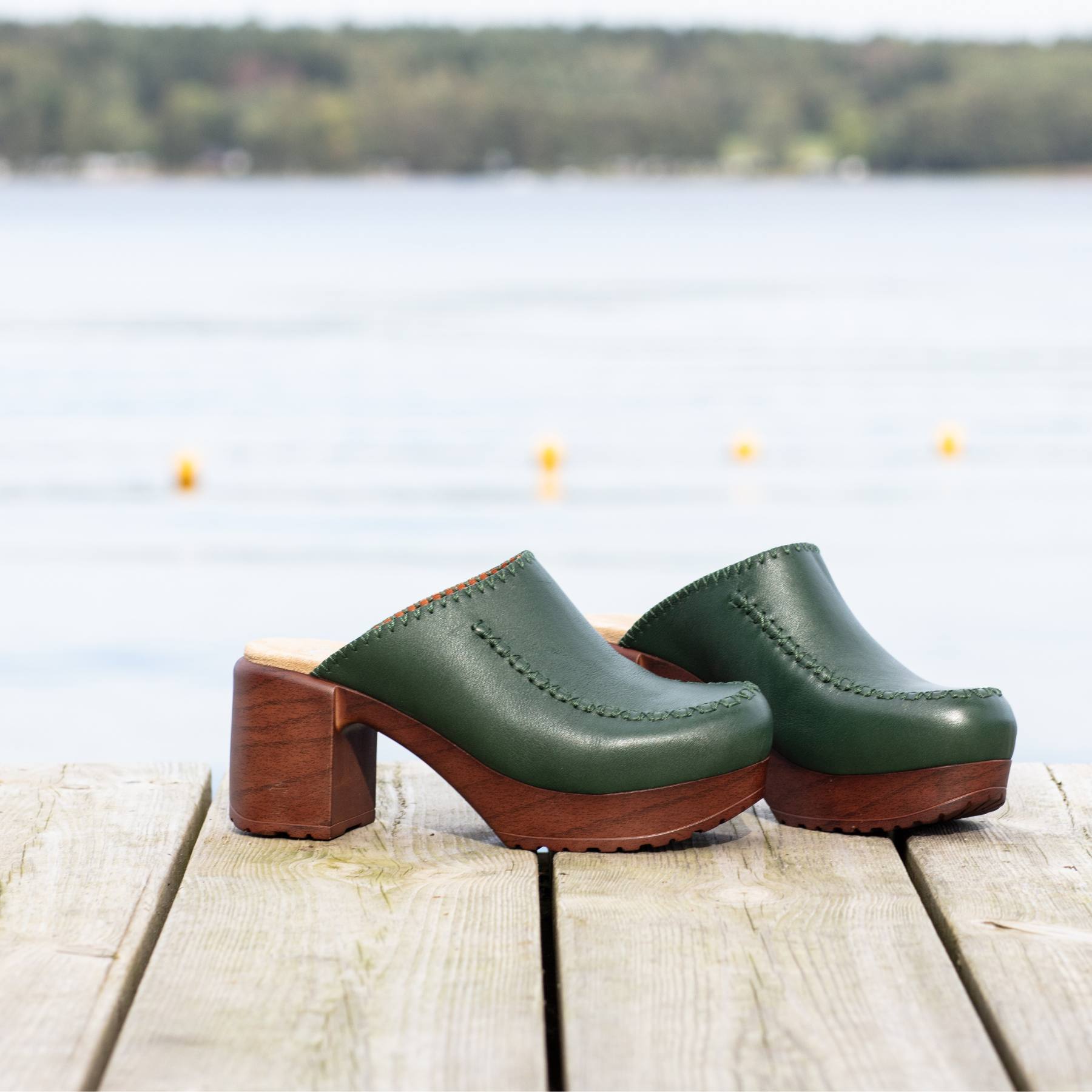 Blenda green leather clogs on dock Calou Stockholm