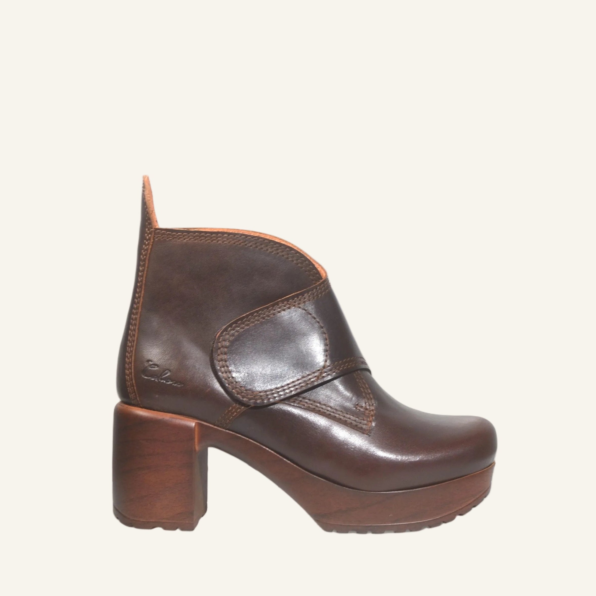 Brown leather ankle boot on a white background