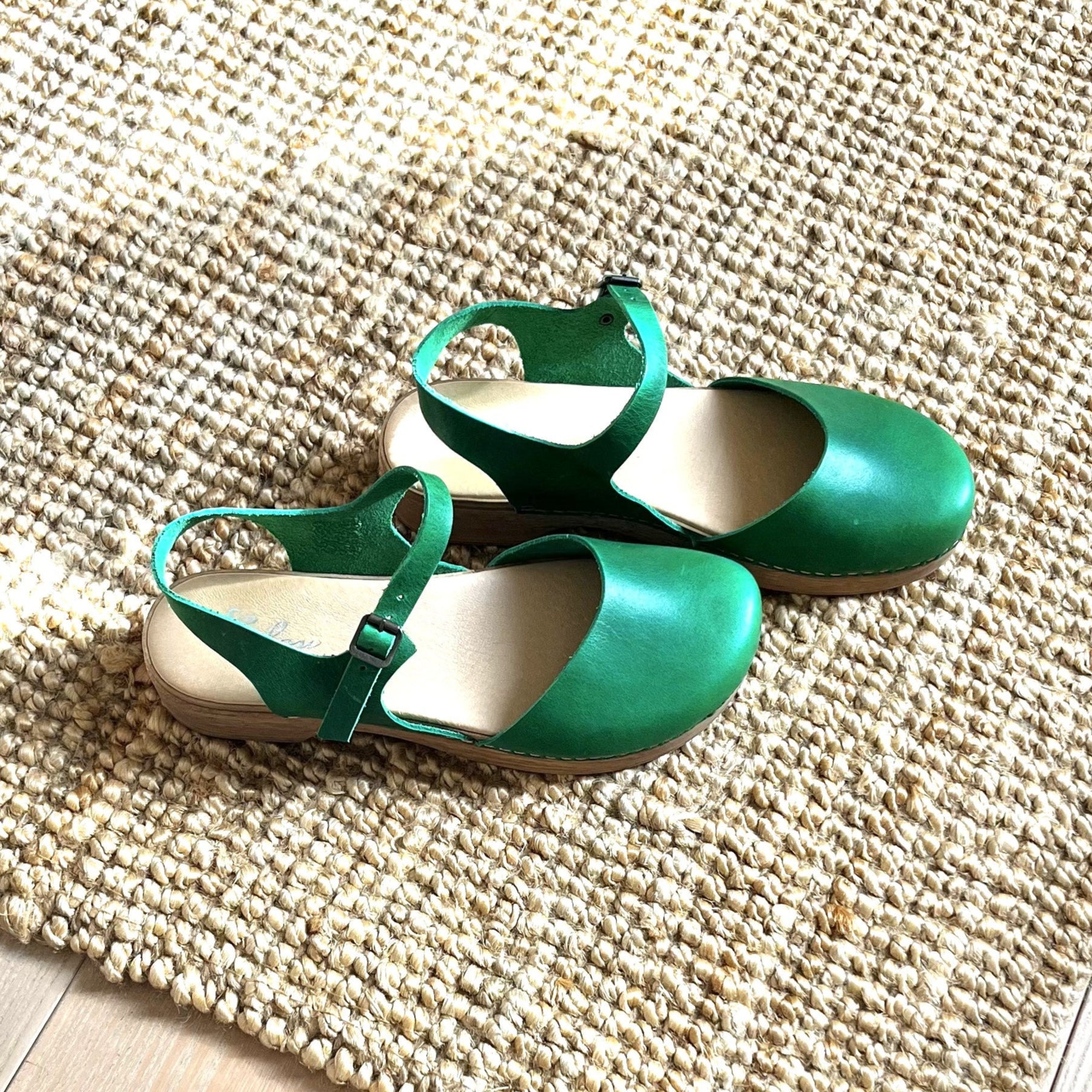 Dianam green leather Mary Jane clogs on beige carpet, Calou Stockholm