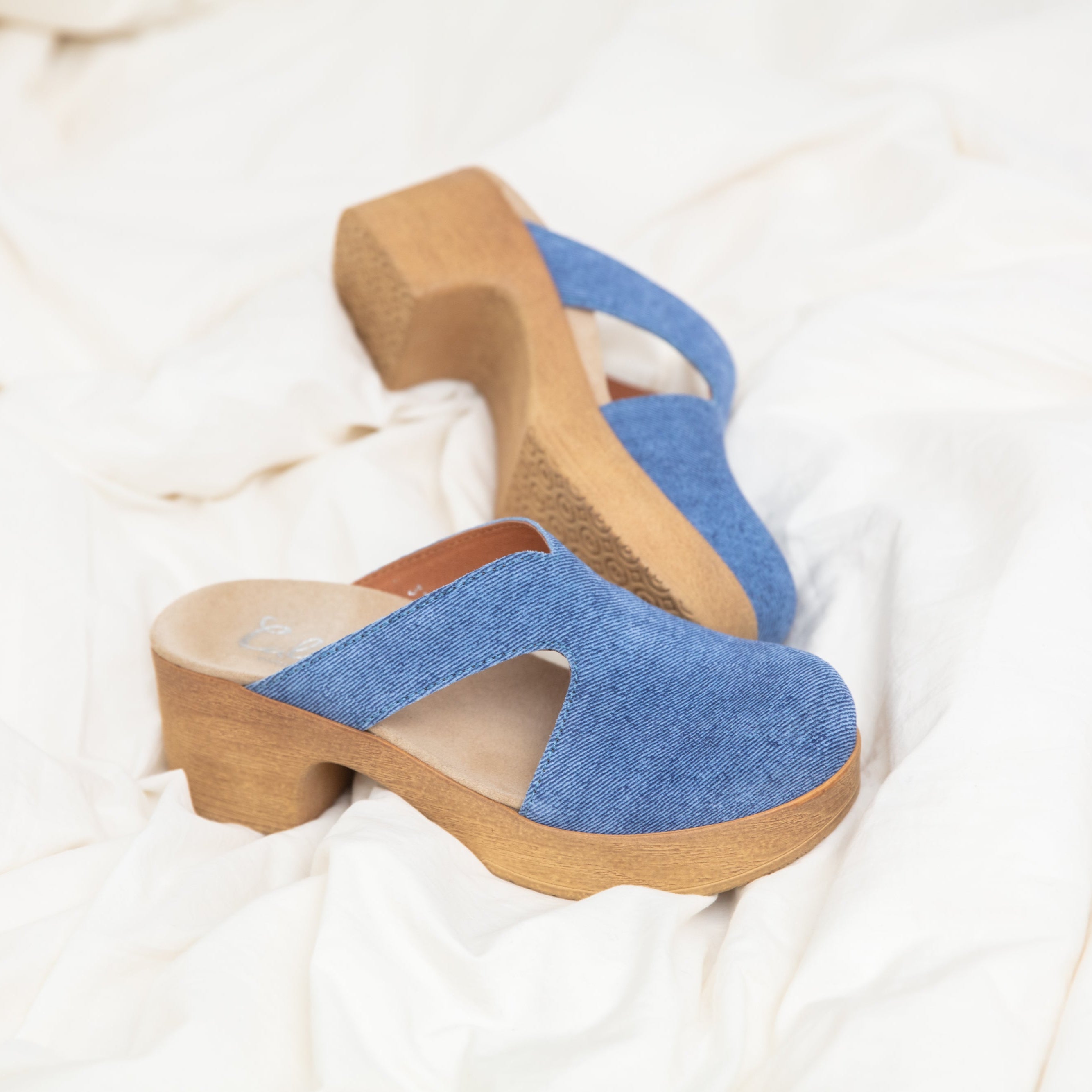 Eivor blue suedeclogs on bed Calou Stockholm