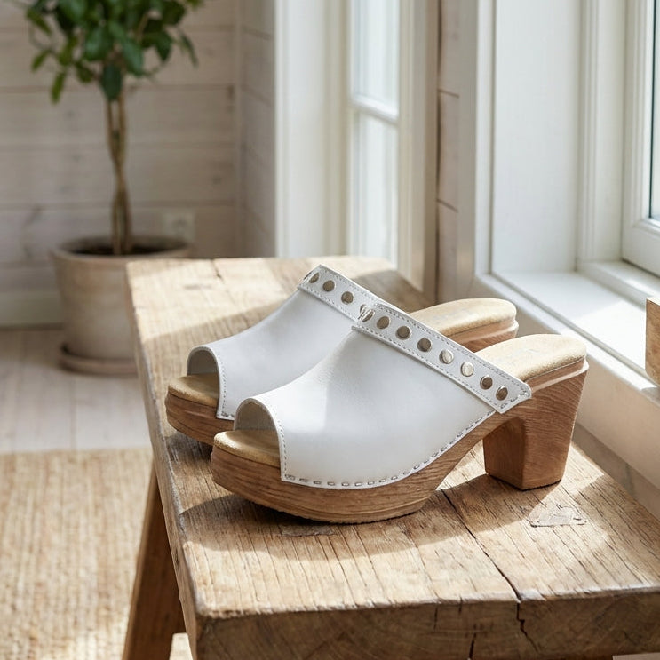 Calou Felicia pair of white clog sandals on soft flexible soles, lifestyle