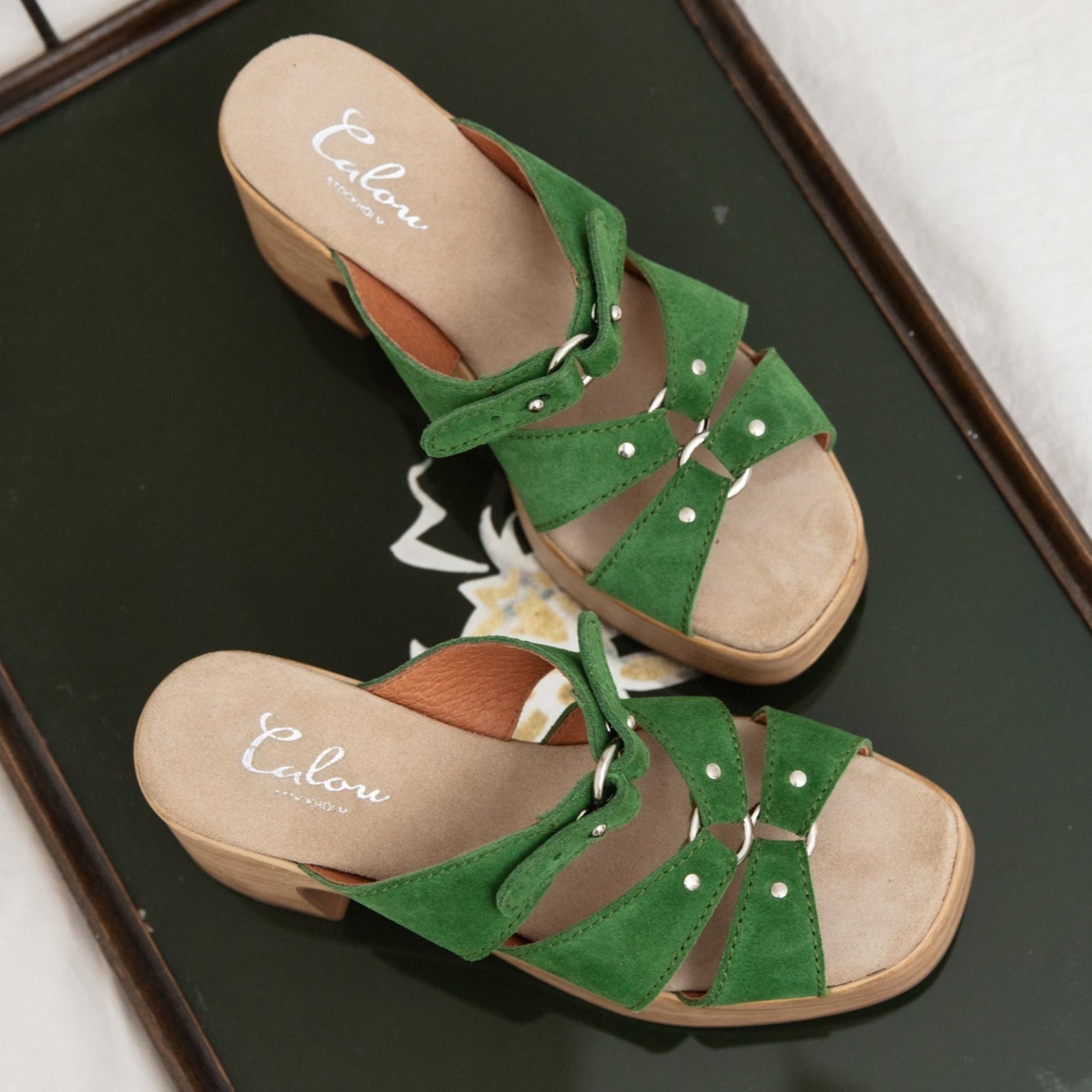 Jenny green suede clog sandals on tray Calou