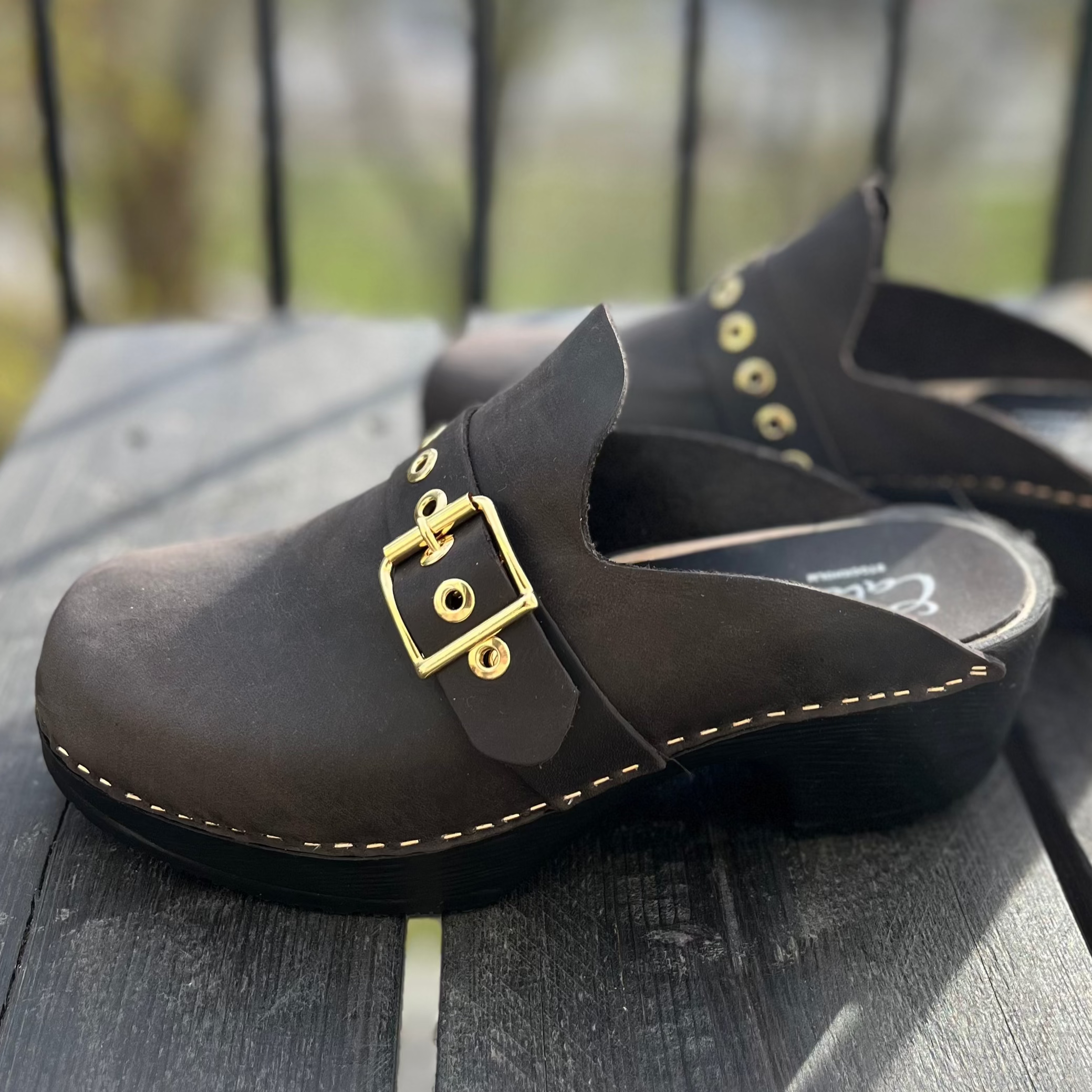 Vanja black leather clogs on deck, Calou Stockholm