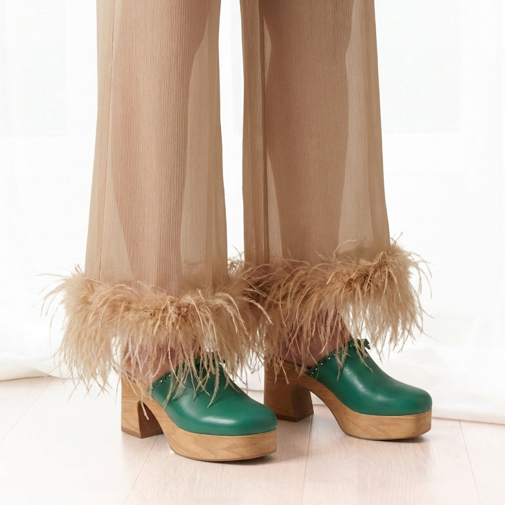 Calou Carla Green leather clogs with flex-soles worn with sheer beige pants on person
