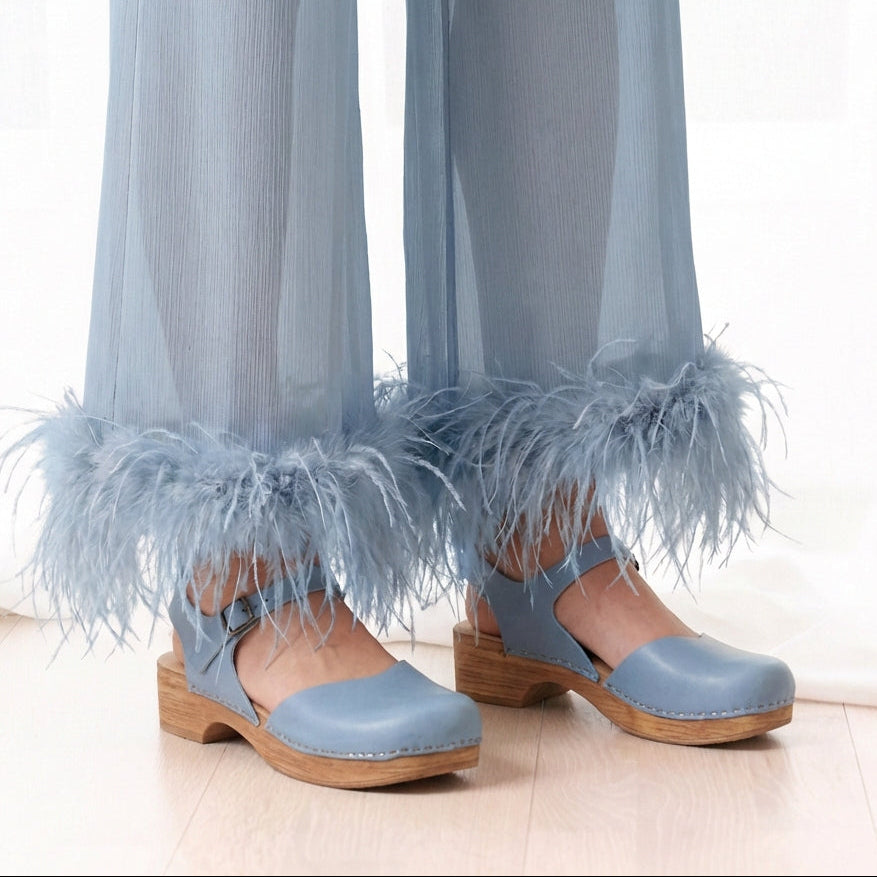 Light blue Mary Jane´s with bendable soles worn with sheer blue pants featuring feathered cuffs.