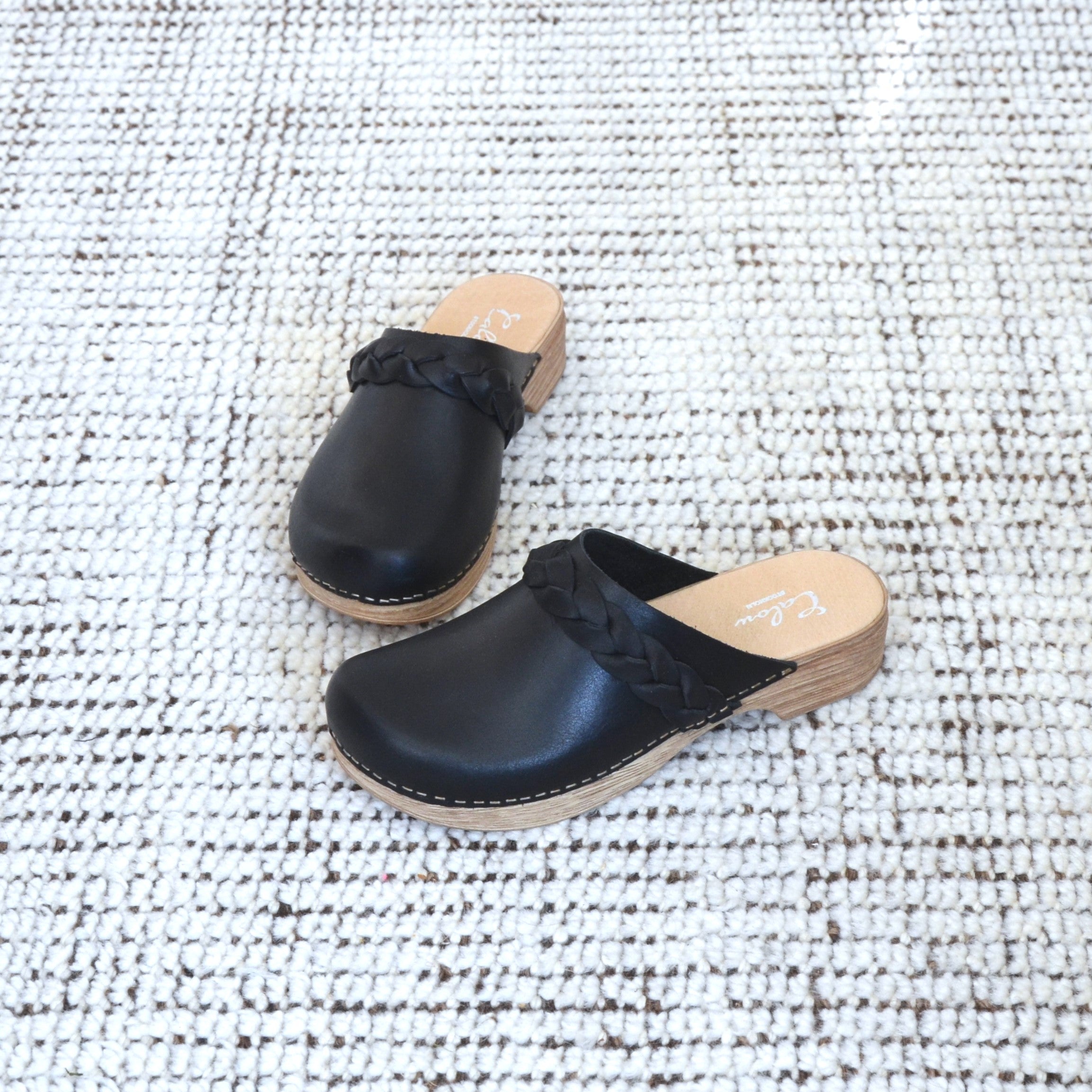 Helena black leather clogs on carpet calou stockholm