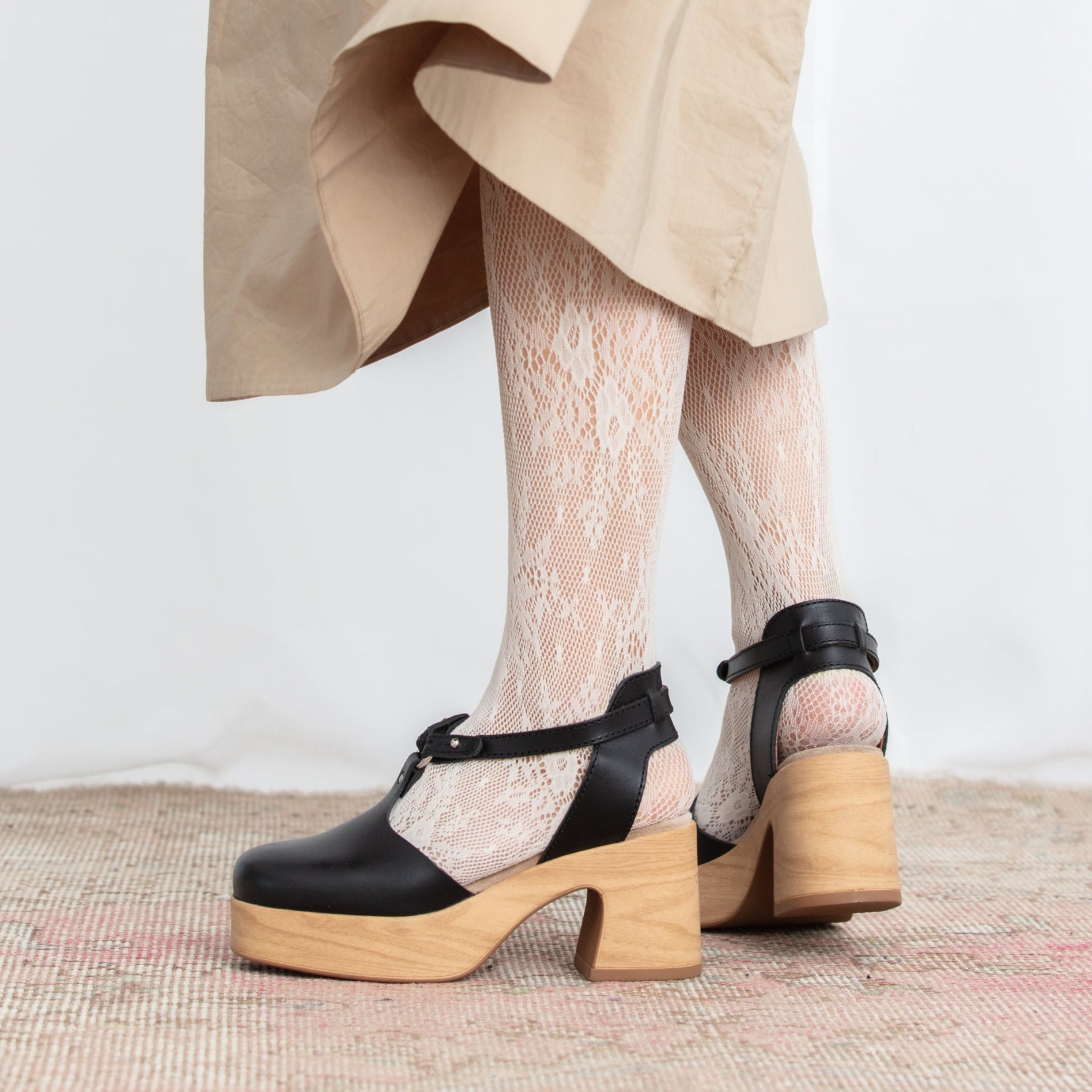 Majsan black leather clogs on model Calou