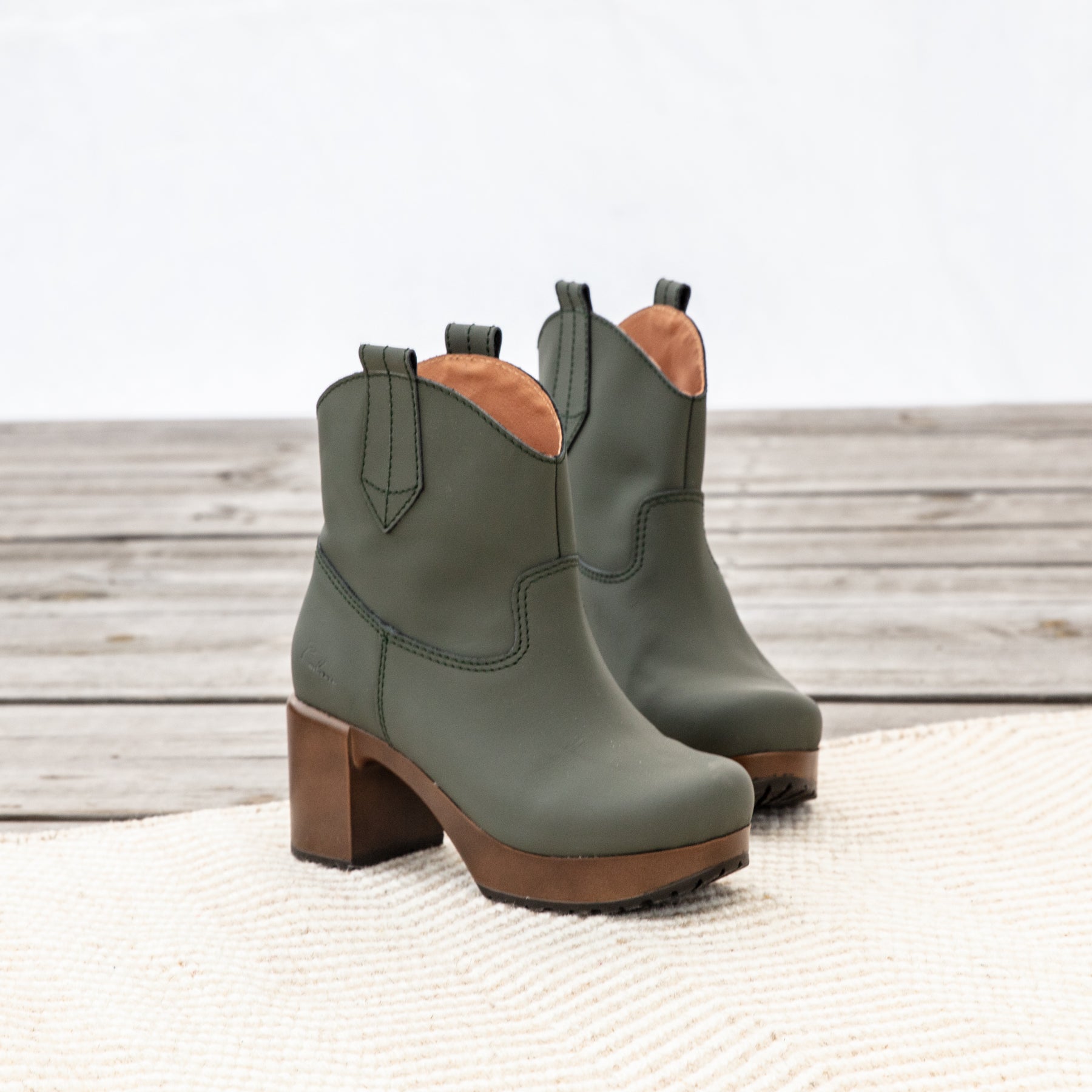 Malin green water reistant leather boots on carpet, Calou Stockholm