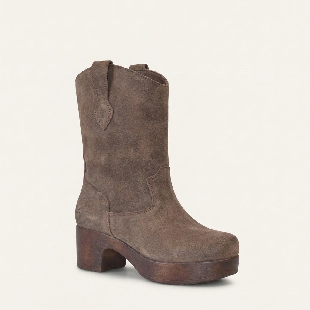 A single mid-calf western-style boot in brown suede with a stacked wood-look block heel, shown on a plain off-white background.