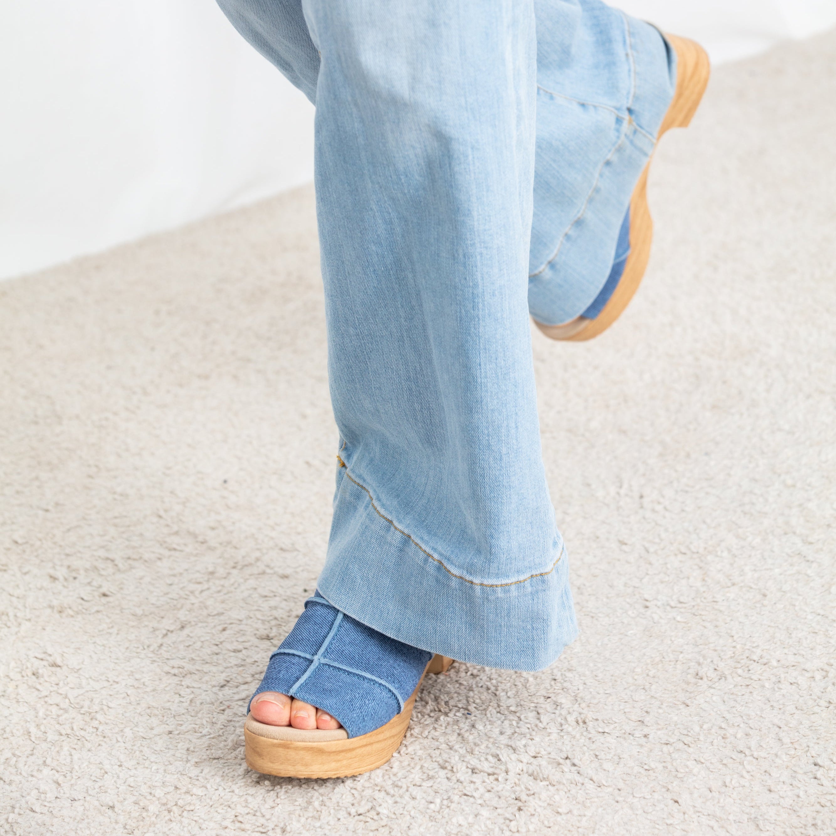 Tova blue denim like suede clog on model Calou