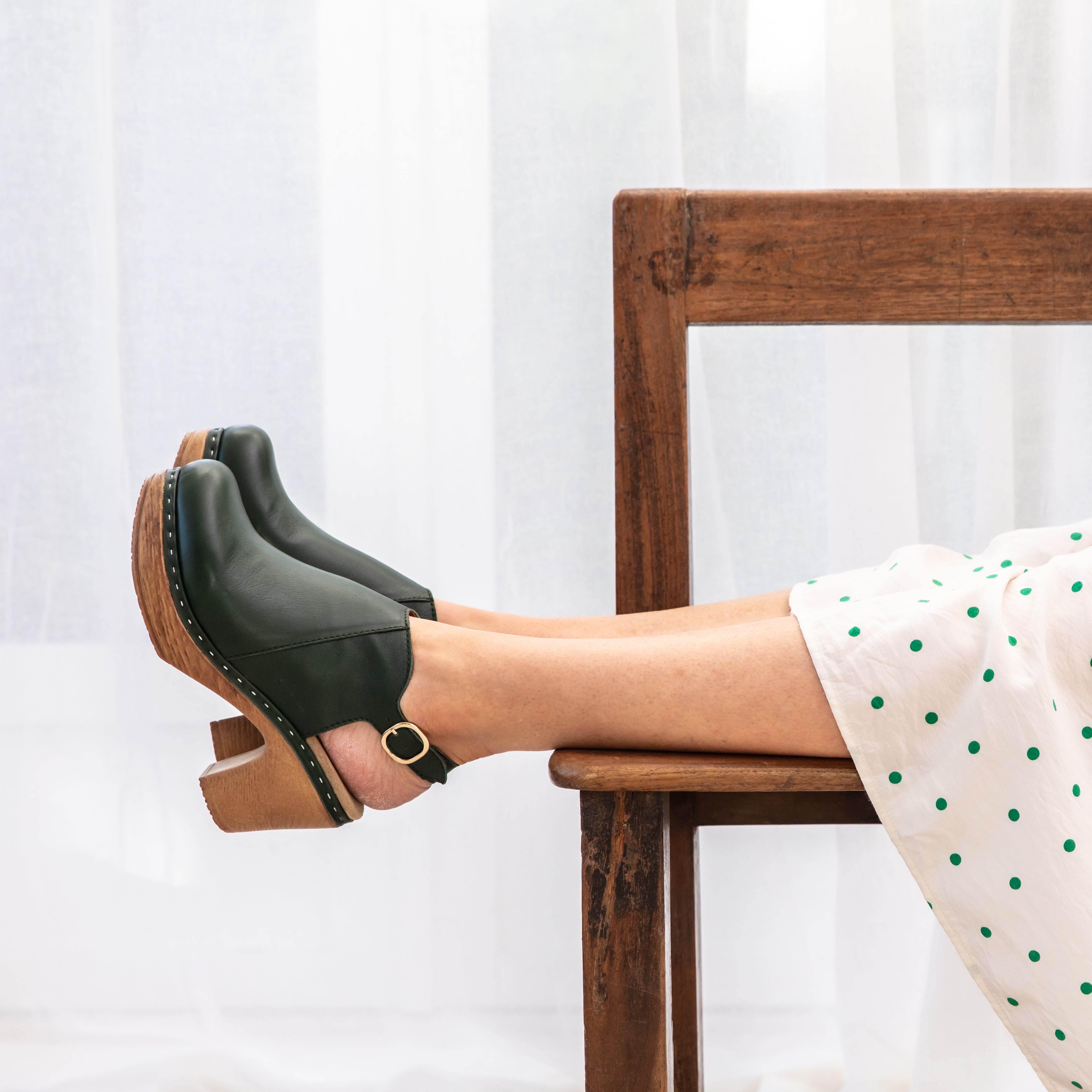 Tyra green leather clogs on model Calou Stockholm