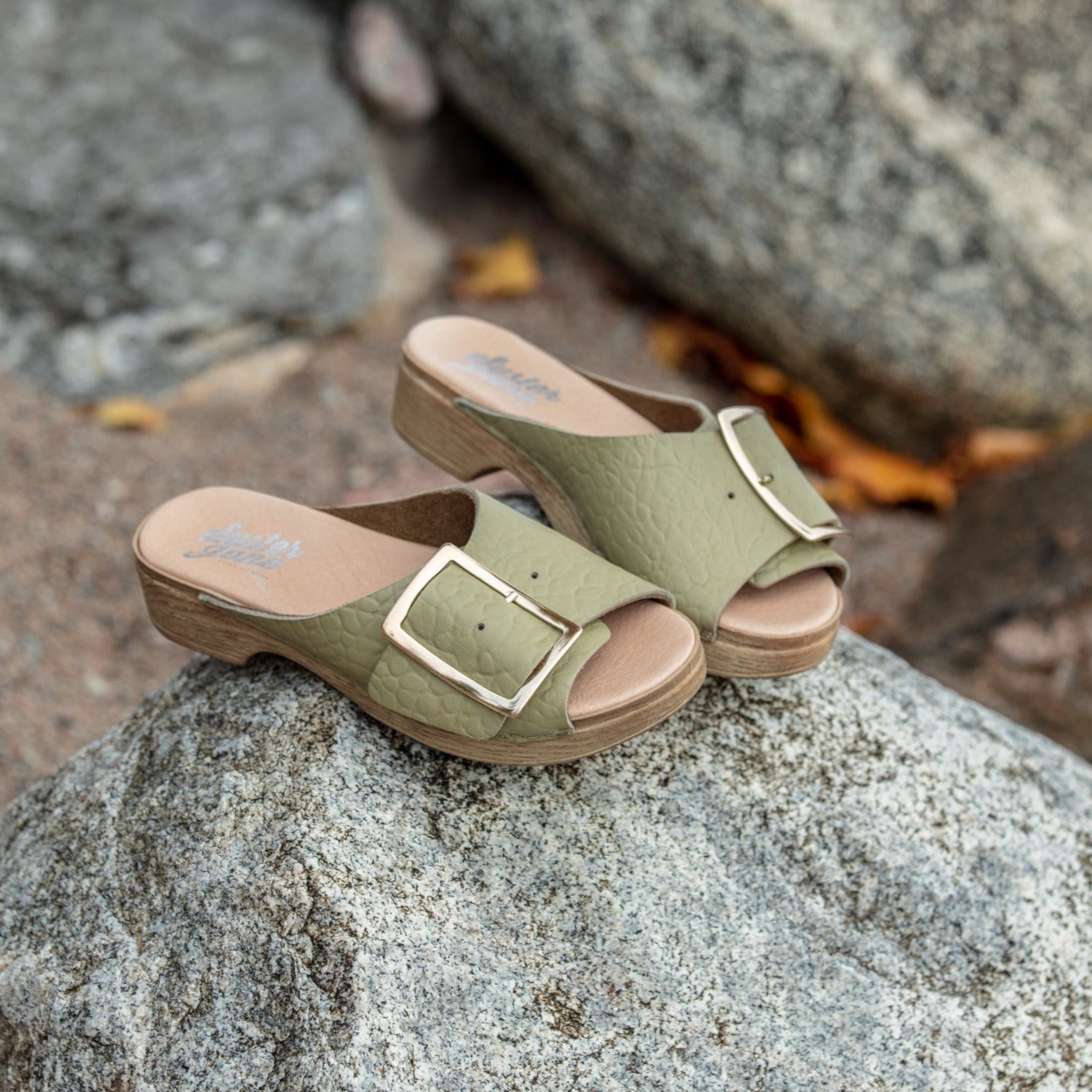 Vega green leather clog sandals on stone, Calou Stockholm